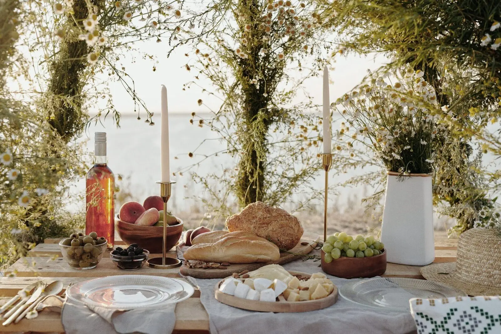 A long table laid outside under the trees