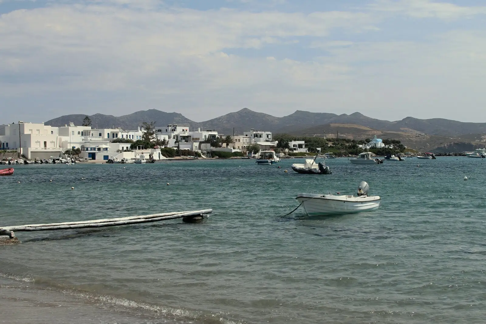 Boats in the little harbour at Pollonia, Milos, with the houses across the water