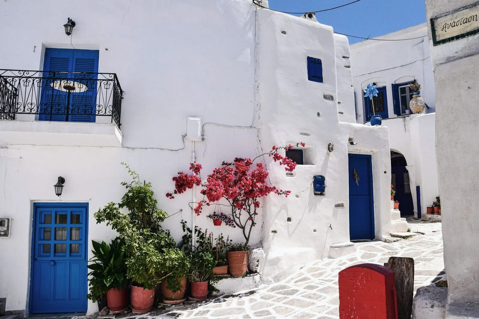 A whitewashed alley with blue doors