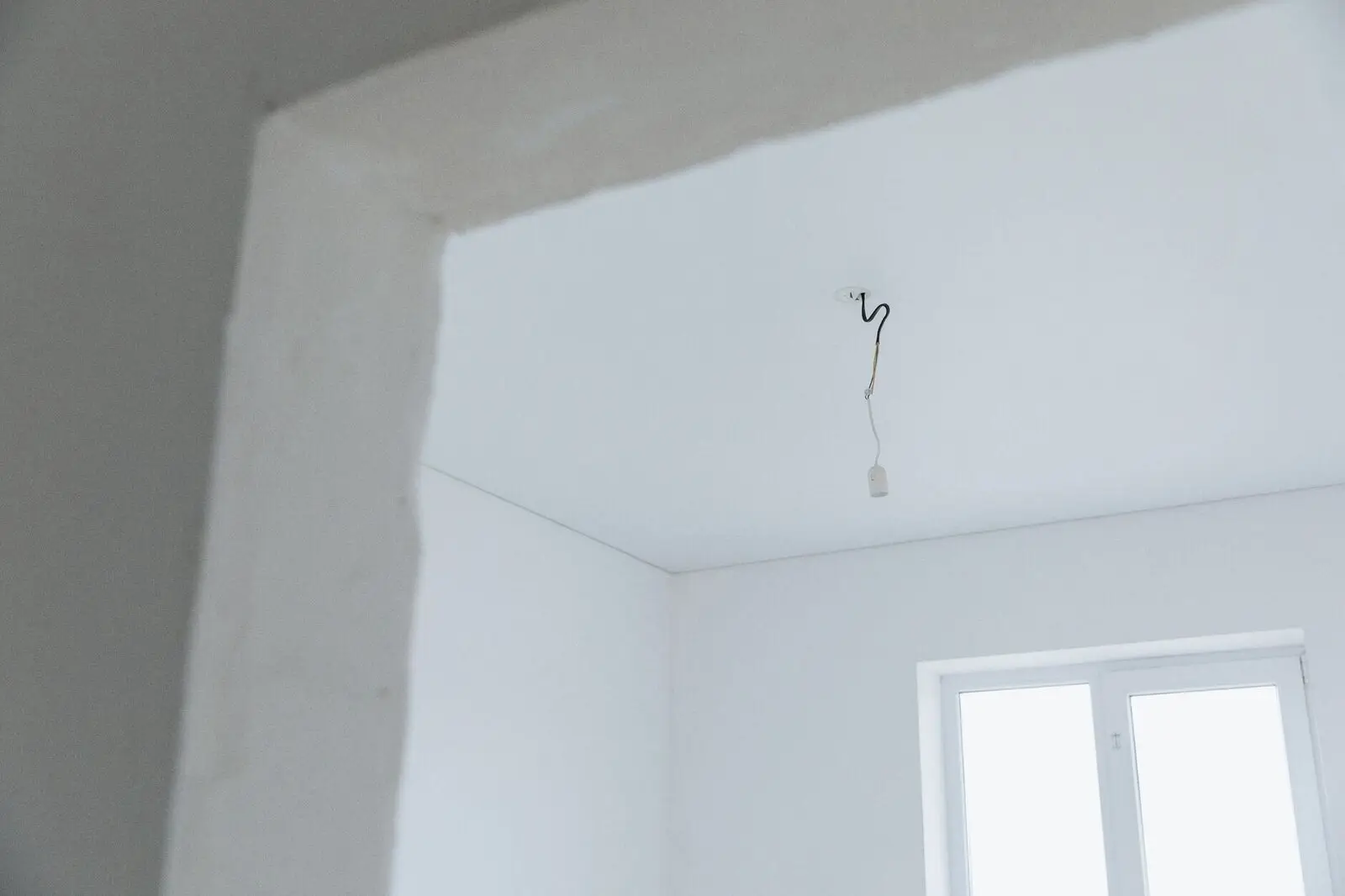 Hand-plastered whitewashed interior in raking light
