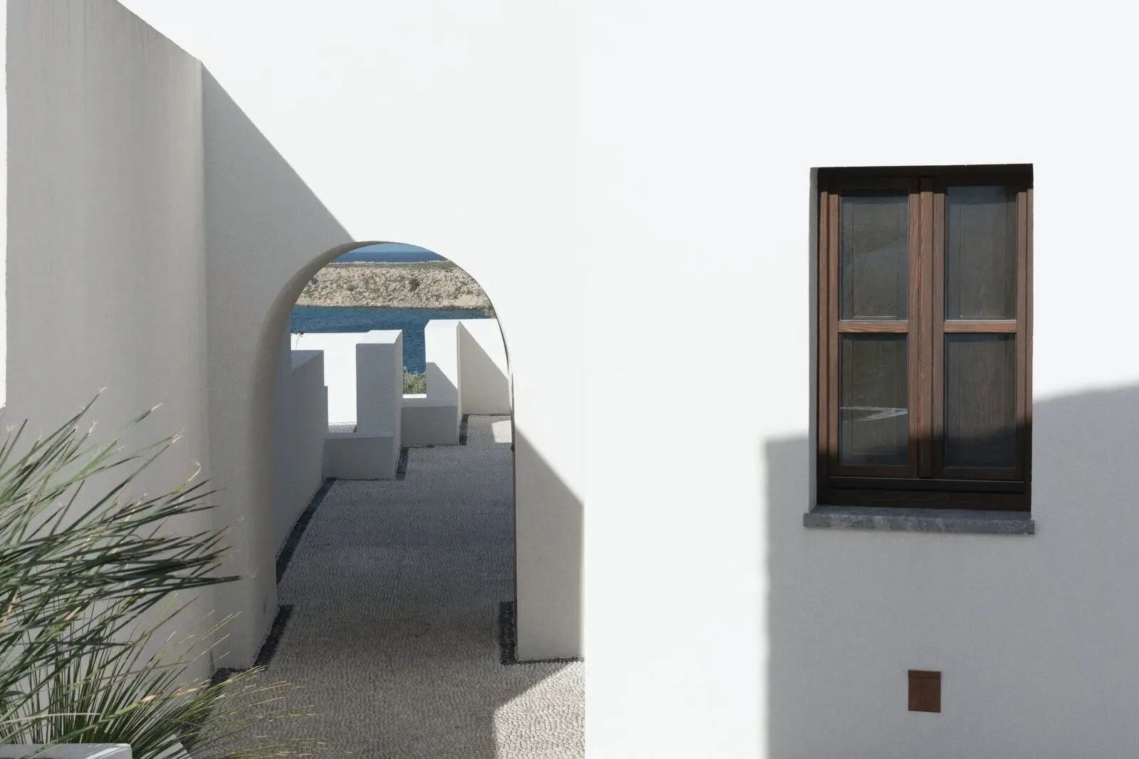A shuttered window against the sky