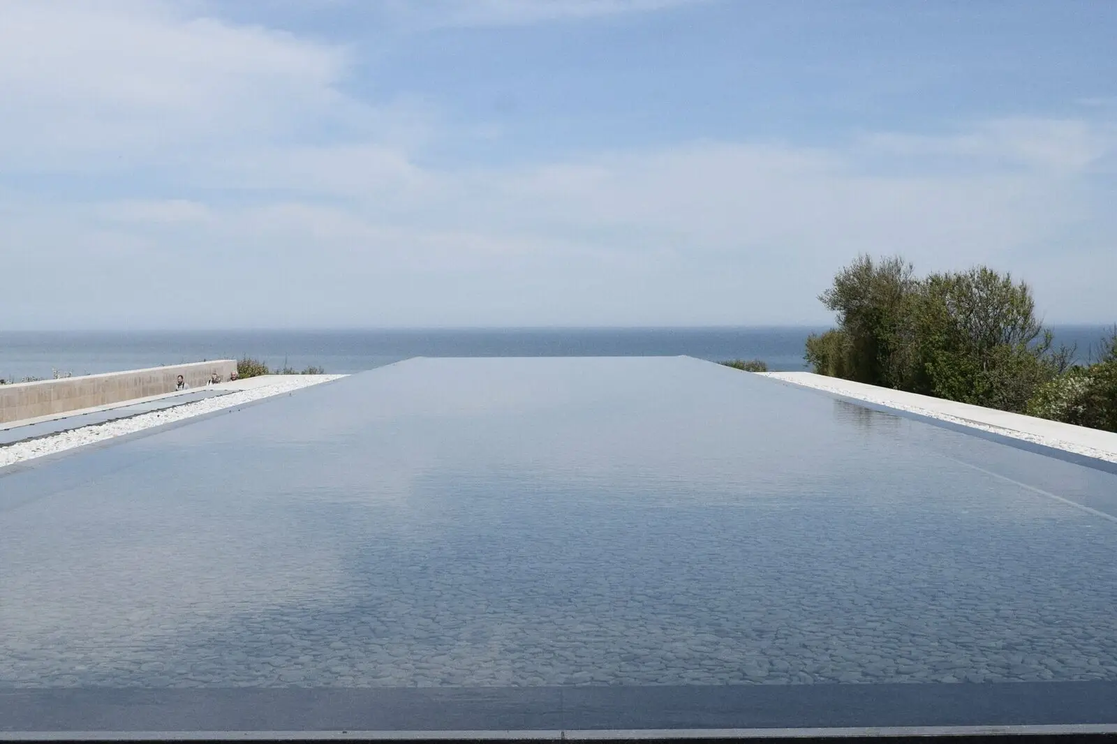 The pool level with the sea beyond it