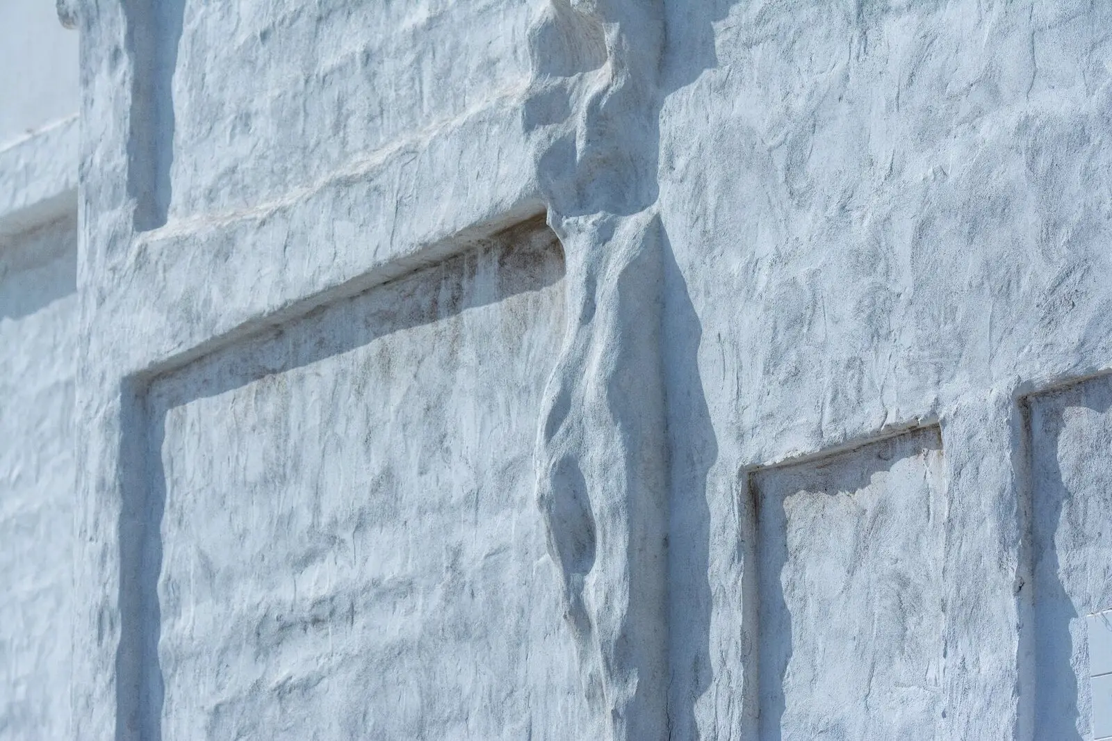 Whitewashed wall texture in blue shadow